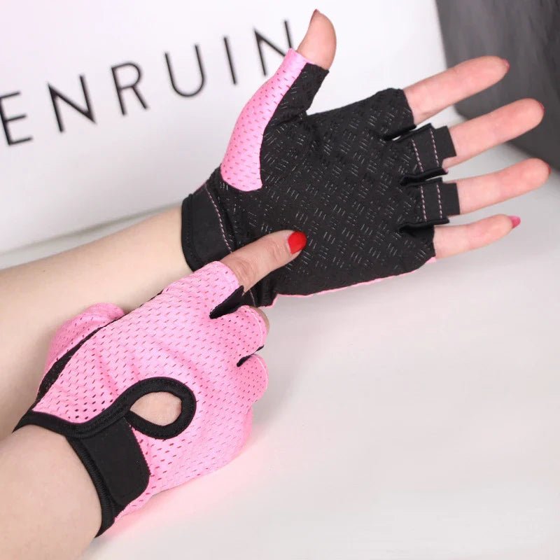 Une main fĂ©minine Ă©quipĂ©e dâun Ă©lĂ©ment textile rose et noir, ajustĂ© au poignet grĂące Ă une attache rĂ©glable. La partie infĂ©rieure est fabriquĂ©e en cuir synthĂ©tique et dotĂ©e de lĂ©gers renforts, destinĂ©s Ă protĂ©ger les mains lors de lâeffort. De petites per